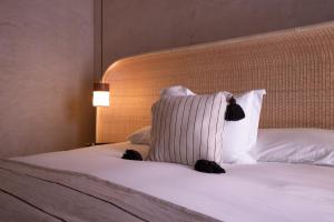 a bedroom with a bed with a white pillow at Casa Antonieta in Oaxaca City