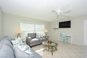 a living room with a couch and a table at Canal 315 - Right in Siesta Key Village! in Siesta Key