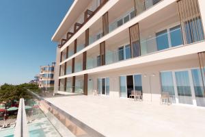 a balcony of a building with a swimming pool at AMR Hotel - Durres in Durrës