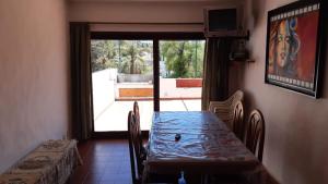 a table and chairs in a room with a window at Departamentos Carlos Paz bajada al lago in Villa Carlos Paz