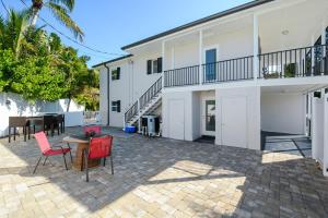 a patio with a table and chairs in front of a building at Canal 313 - Right in Siesta Key Village! in Siesta Key