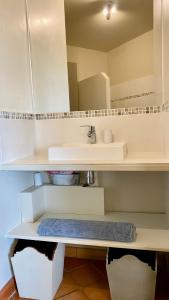 a white bathroom with a sink and a counter at Hameau des amandiers-vue mer & golf in Saint-Cyr-sur-Mer