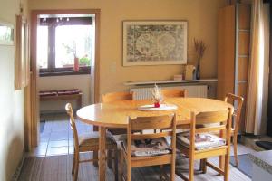 a dining room with a wooden table and chairs at Apartment, Beetzseeheide in Ketzür