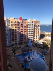 a view of a resort with a swimming pool and buildings at Playa Honda vistas al mar, 1a Línea playa, PARKING, WIFI in Playa Honda