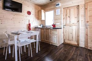 a kitchen with a table and chairs in a cabin at Holiday complex, Jezierzany in Jezierzany