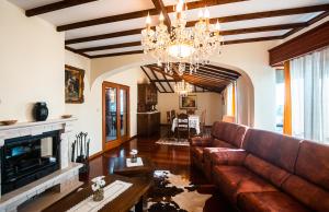 a living room with a couch and a fireplace at Azores Apartment in Ponta Delgada