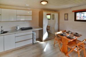 a kitchen and dining area of a tiny house at Holiday homes close to the beach Sarbinowo in Sarbinowo