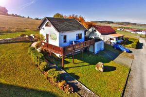 a blue and white house on a grass field at Ferienhaus Rhönblick, Kaltensundheim in Kaltensundheim