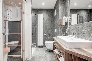 Kúpeľňa v ubytovaní Sporthotel Olymp