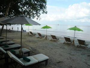 a group of chairs and umbrellas on a beach at Banpu Koh Chang Resort in Ko Chang