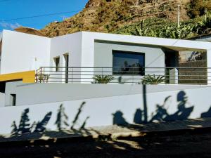 a shadow of a house on a white wall at Anjos's Choice in Ponta do Sol