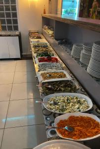 a buffet line with many plates of food at Denizhan Hotel in Antalya