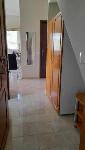 a room with a hallway with a large wooden cabinet at Sunrise Apartment in Souda