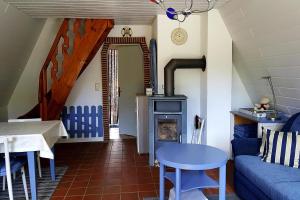 a living room with a blue couch and a stove at Cottage, Perlin in Perlin