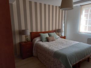 A bed or beds in a room at Apartamento a 350 metros de la playa