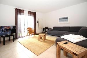 a living room with a couch and a table at Holiday home Barbara, Zarrentin in Zarrentin