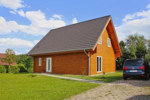 a house with a car parked in front of it at Holiday home Barbara, Zarrentin in Zarrentin