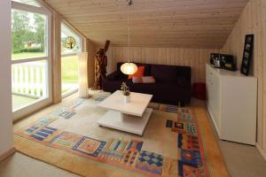 a living room with a couch and a table at Ferienhaus mit Sauna am Dümmer See, Dümmer in Dümmer