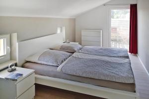 a bedroom with a large bed and a window at Vacation home Bel Ami, Nakenstorf in Nakensdorf