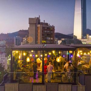 a crowd of people standing around a food stand at Hotel Nodo - Primer hotel explorador urbano in Santiago