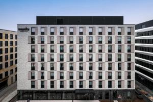 a large white building with many windows at Staycity Aparthotels Frankfurt Airport in Frankfurt/Main