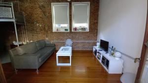 a living room with a couch and a table at Nice Apart en Caballito. Visitá Buenos Aires in Buenos Aires