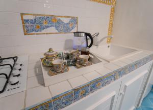 a kitchen counter with a sink and a coffee maker at Postcard House in Vico Equense