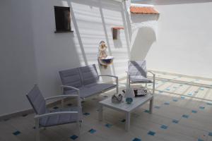 a patio with two chairs and a table at Postcard House in Vico Equense