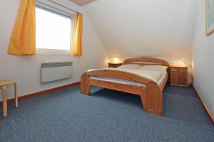 1 dormitorio con cama de madera y ventana en Holiday resort in the M ritz National Park Mirow, en Mirow