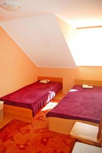 two beds in a room with red sheets at Terraced house, Rewal in Rewal