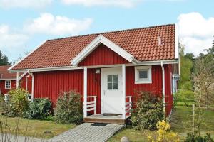 a red house with a red roof at Holiday house at the Useriner See, Userin in Userin