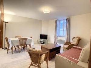 a living room with a table and a dining room at Boutons d'or in Tierceville
