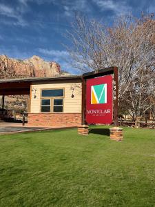 a sign for a museum in front of a building at Montclair Inn & Suites at Zion National Park in Springdale