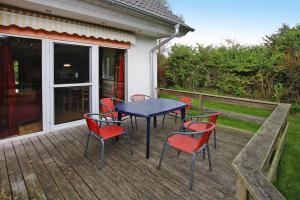 a patio with a table and chairs on a deck at Holiday resort in the Müritz National Park, Mirow in Mirow