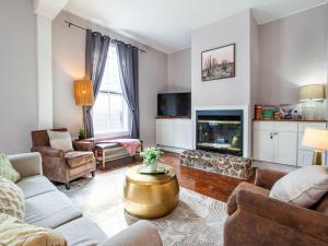 a living room with a couch and a fireplace at Bright Old City Loft in Knoxville