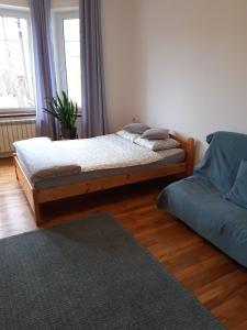 a bedroom with two beds and a couch at Green Apartment House in Bielsko-Biała