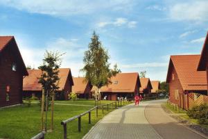 a woman walking down a road between two houses at Ferienhaus in Hasselfelde in Hasselfelde