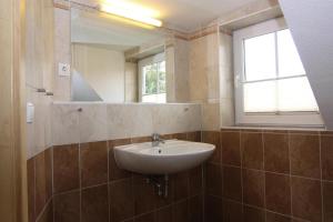 a bathroom with a sink and a mirror at Doppelhaushälfte, Kühlungsborn in Kühlungsborn +14 photos