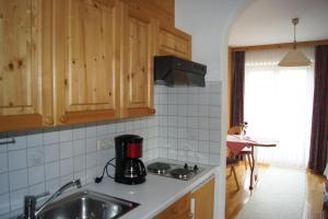 a kitchen with a sink and a counter top at Ferienwohnungen Billovits in Kössen