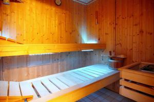 a sauna with a bench and a bucket in it at House, Zirchow Usedom in Zirchow