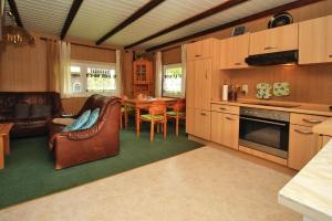 a kitchen and living room with a table and chairs at Boathouse, Teterow in Teterow