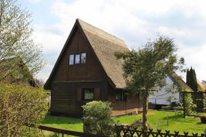 a large wooden house with a gambrel roof at Boathouse, Teterow in Teterow