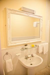 a white bathroom with a sink and a mirror at The Kerryway in Flesk Bridge
