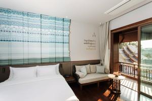 Ein Bett oder Betten in einem Zimmer der Unterkunft T Heritage Hotel