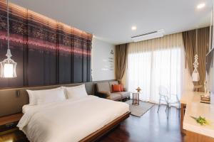Ein Bett oder Betten in einem Zimmer der Unterkunft T Heritage Hotel