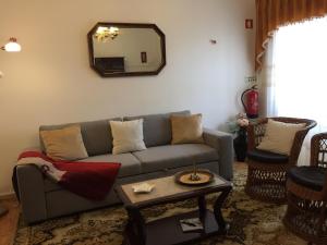 a living room with a couch and a mirror at Casa da Venda do Ferrador in Estremoz +18 photos