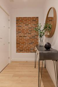 a room with a chair and a brick wall at Room4You Oviedo by Asturias Holidays in Oviedo