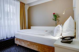Postel nebo postele na pokoji v ubytování Hotel Fürst Bismarck