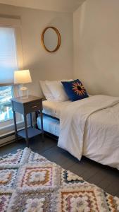 a bedroom with two beds and a table with a lamp at Lewisburg duplex in Lewisburg