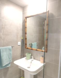 a bathroom with a sink and a mirror at Apartamento a estrenar en Villanúa in Villanúa +27 photos